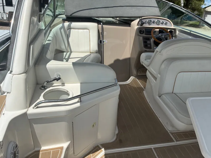 Slide: The Image of The image shows the cockpit of a 1998 Sea Ray 290 Sundancer with beige seating and wood accents. - 10