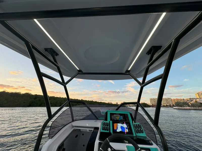 Slide: The Image of 2025 Ranieri CAYMAN 27.0 SPORT TOURING boat interior with modern dashboard and scenic water view. - 33