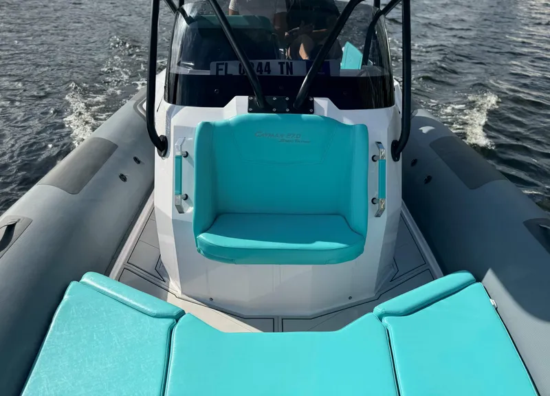 Slide: The Image of 2025 Ranieri CAYMAN 27.0 SPORT TOURING boat with turquoise seating on the water. - 8