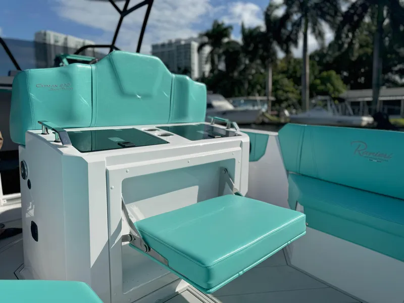Slide: The Image of 2025 Ranieri CAYMAN 27.0 SPORT TOURING with turquoise seating, modern design, and outdoor setting. - 24