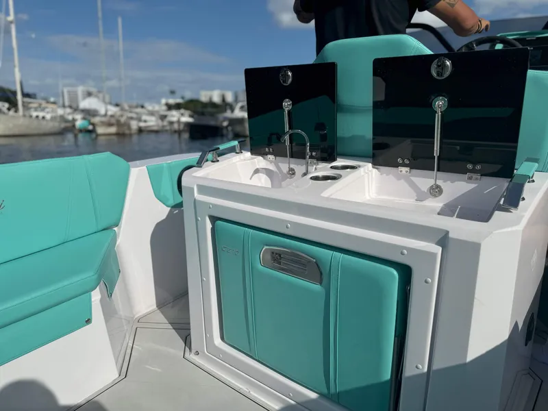 Slide: The Image of 2025 Ranieri CAYMAN 27.0 SPORT TOURING boat interior with teal seating and sink area. - 22