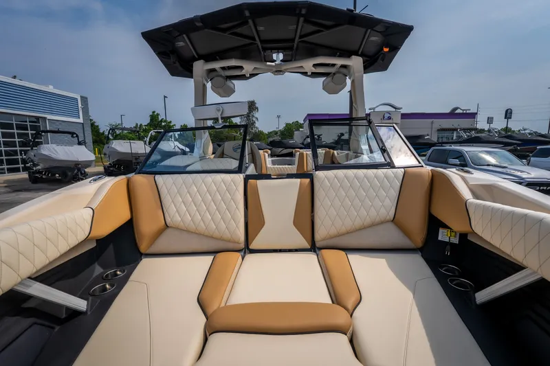 Slide: The Image of 2026 Tigé Z3 boat interior with luxurious tan and white seating, docked outdoors. - 42
