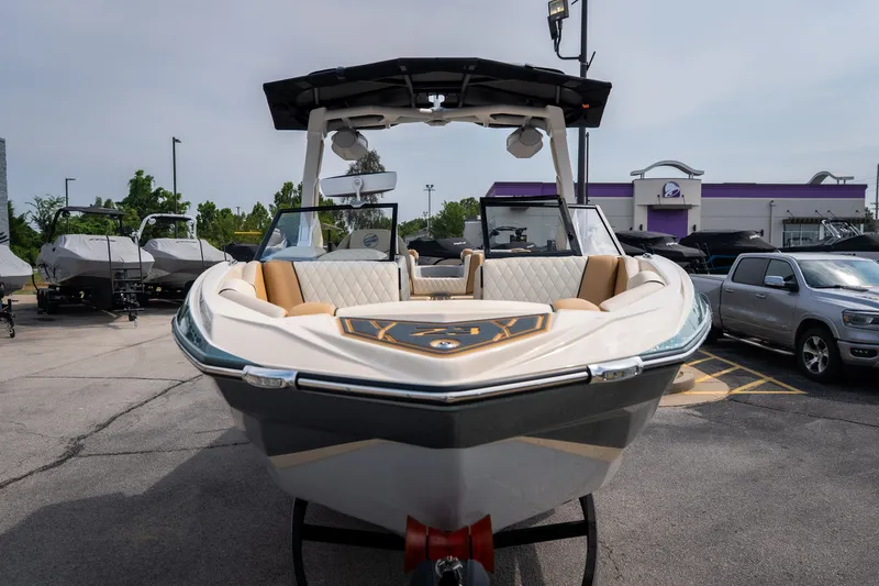 Slide: The Image of 2026 Tigé Z3 boat displayed in a parking lot with other vehicles. - 13