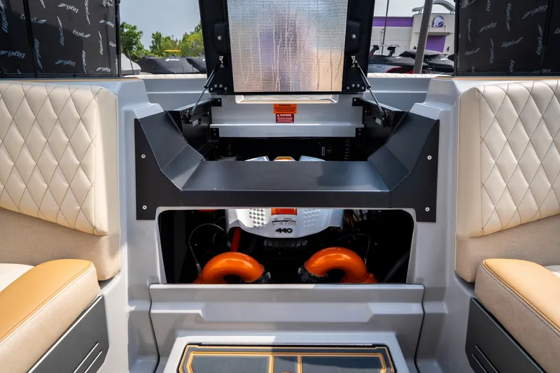 Slide: The Image of 2026 Tigé Z3 boat engine compartment with quilted seating and vibrant orange accents. - 62