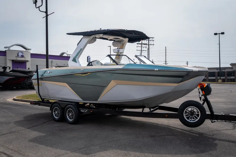 Slide: The Image of 2026 Tigé Z3 boat on trailer in parking lot, showcasing sleek design and modern features. - 12