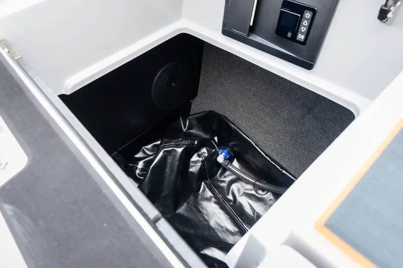Slide: The Image of 2026 Tigé Z3 boat storage compartment with black lining and control panel. - 61