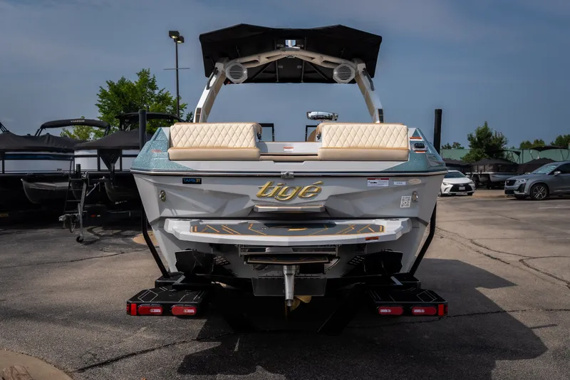 Slide: The Image of 2026 Tigé Z3 boat rear view in a parking lot, showcasing sleek design and seating. - 15