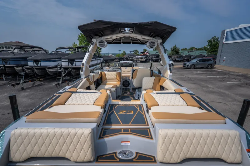 Slide: The Image of 2026 Tigé Z3 boat interior with luxurious seating and modern design in a marina setting. - 23