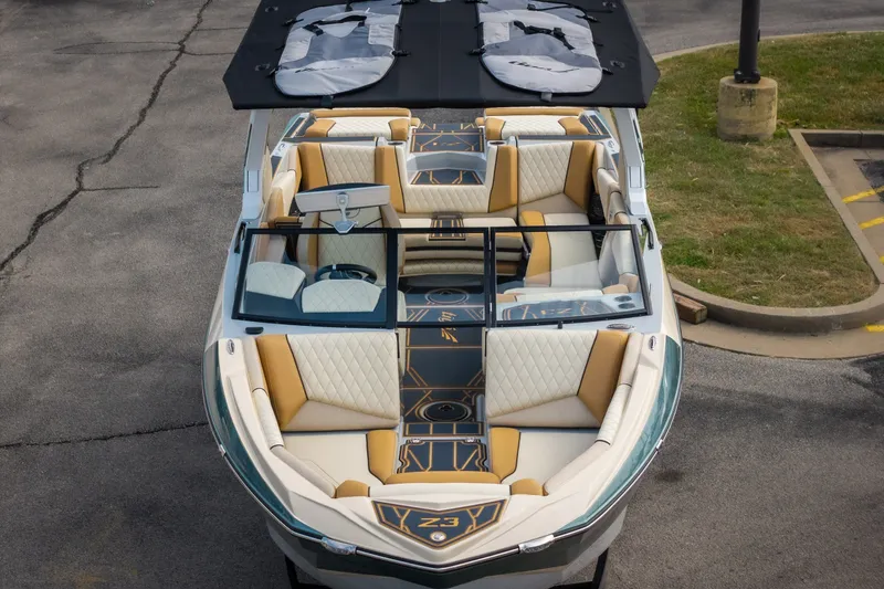 Slide: The Image of 2026 Tigé Z3 boat with luxurious seating and sleek design, parked on pavement. - 10