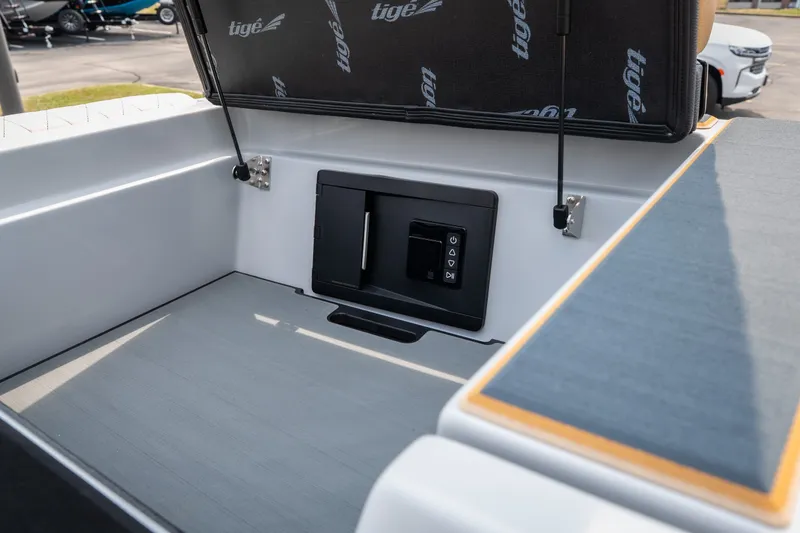 Slide: The Image of 2026 Tigé Z3 boat storage compartment with open lid and control panel. - 60