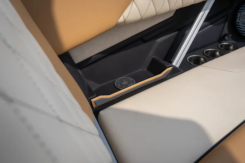 Slide: The Image of 2026 Tigé Z3 interior detail with beige upholstery, cup holders, and speaker. - 53
