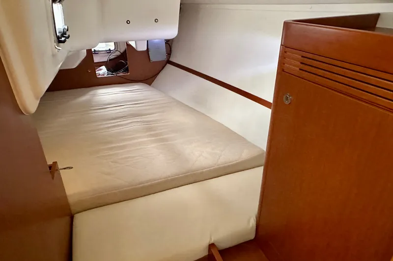 Slide: The Image of Interior cabin of 2015 Beneteau Oceanis 31 sailboat with wooden finish and mattress. - 18