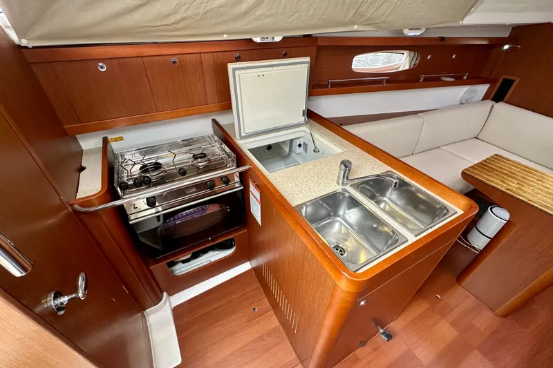 Slide: The Image of Interior of 2015 Beneteau Oceanis 31 yacht with kitchen and seating area. - 15