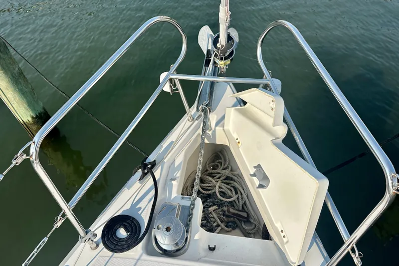 Slide: The Image of Bow of 2015 Beneteau Oceanis 31 sailboat with anchor and ropes visible. - 11