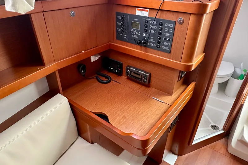 Slide: The Image of Navigation station on 2015 Beneteau Oceanis 31 yacht with control panel and radio equipment. - 16