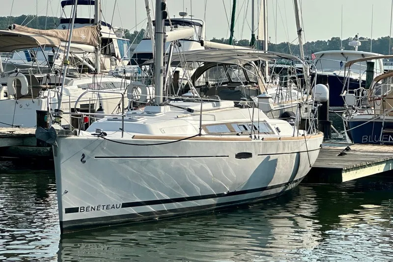The Image of 2015 Beneteau Oceanis 31 sailboat docked at a marina, surrounded by other boats. - 1