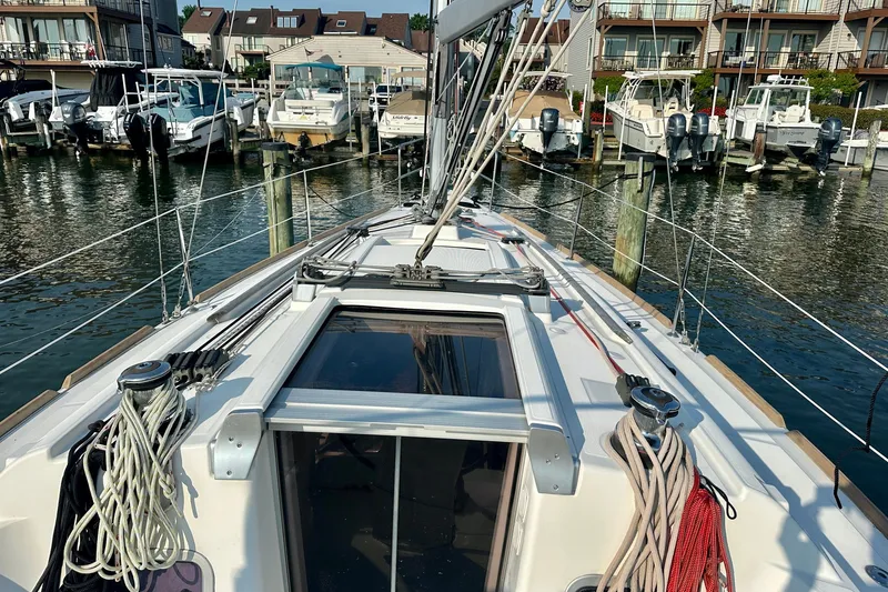 Slide: The Image of Beneteau Oceanis 31 sailboat docked at marina, showcasing deck and rigging, 2015 model. - 8