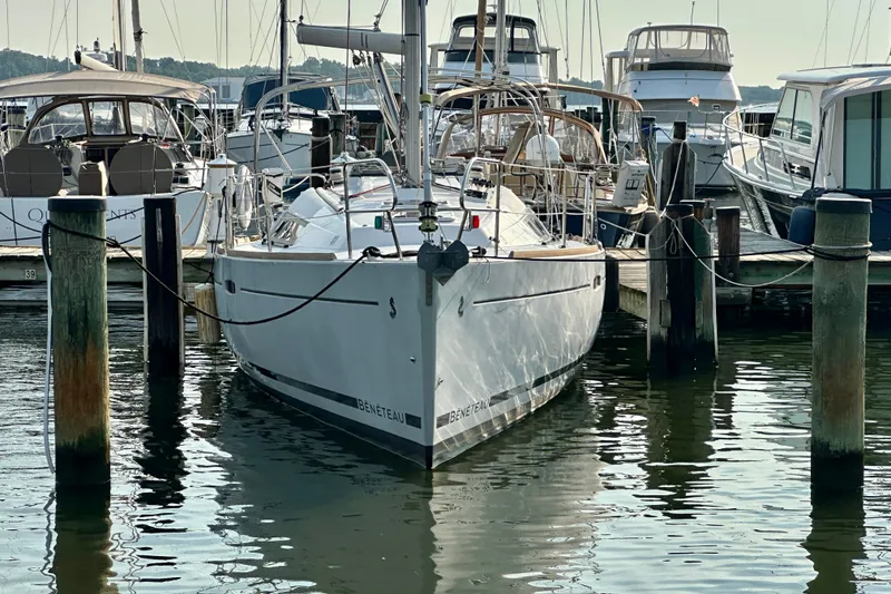 Slide: The Image of Beneteau Oceanis 31 sailboat docked at marina, 2015 model, surrounded by other boats. - 3