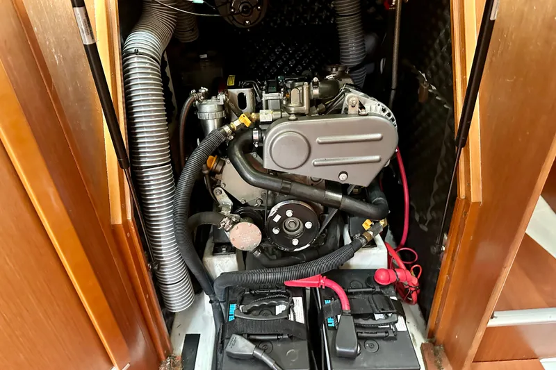 Slide: The Image of Engine compartment of a 2015 Beneteau Oceanis 31 sailboat, showcasing mechanical components. - 19