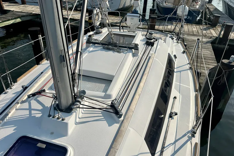 Slide: The Image of 2015 Beneteau Oceanis 31 sailboat docked at marina, showcasing deck and rigging. - 10