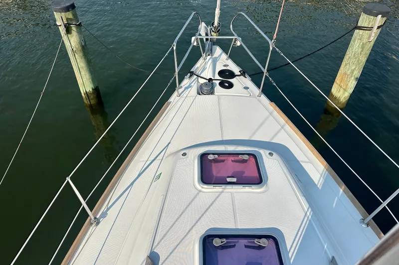 Slide: The Image of Beneteau Oceanis 31 sailboat deck, 2015 model, docked between wooden posts. - 9