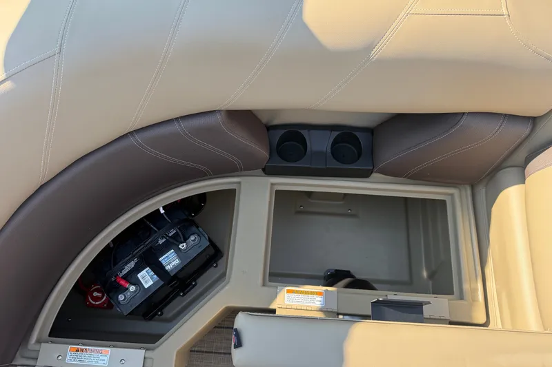 Slide: The Image of Interior view of 2023 Sylvan Mirage X X1 boat storage compartment with battery and cup holders. - 41