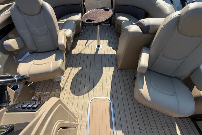 Slide: The Image of Luxurious interior of 2023 Sylvan Mirage X X1 pontoon boat with plush seating and table. - 13