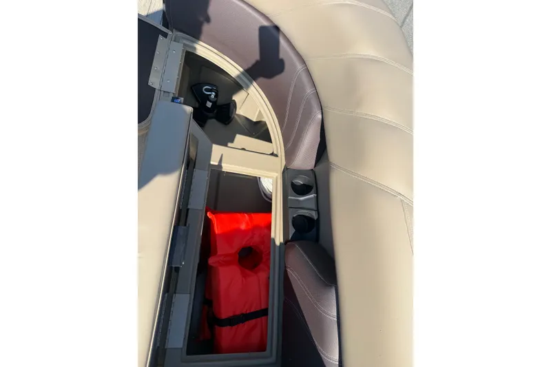 Slide: The Image of Storage compartment in 2023 Sylvan Mirage X X1 boat with life jacket and cup holders. - 39
