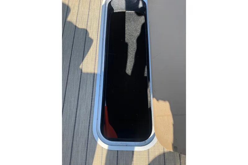 Slide: The Image of 2023 Sylvan Mirage X X1 boat storage compartment with open hatch on deck. - 35