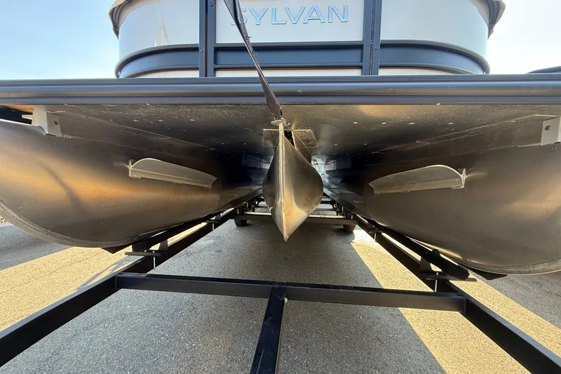Slide: The Image of 2023 Sylvan Mirage X X1 pontoon boat underside view on trailer. - 47