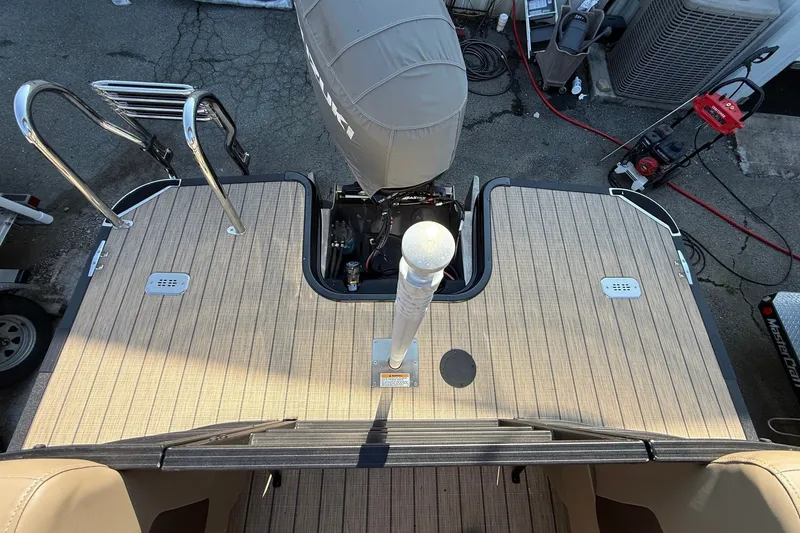 Slide: The Image of 2023 Sylvan Mirage X X1 boat deck with motor and ladder, viewed from above. - 17
