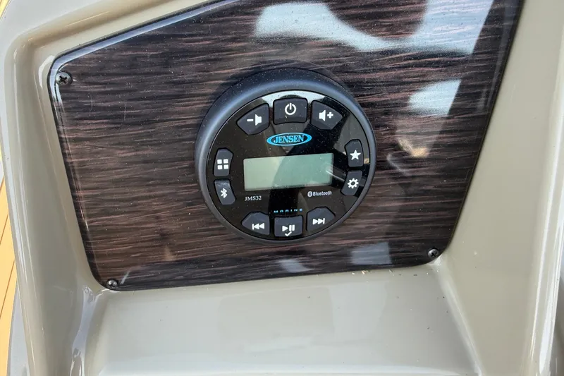 Slide: The Image of 2023 Sylvan Mirage X X1 boat dashboard with Jensen Bluetooth stereo system. - 29
