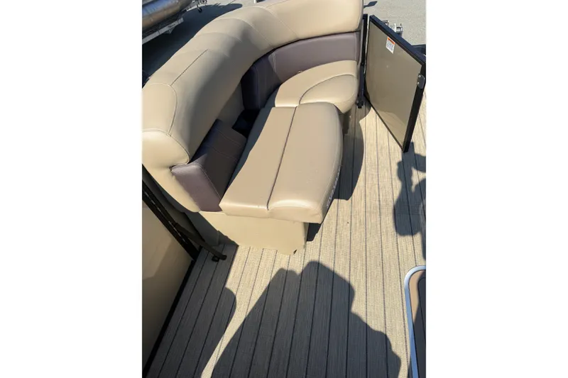 Slide: The Image of 2023 Sylvan Mirage X X1 boat interior with beige seating and wood-textured flooring. - 37