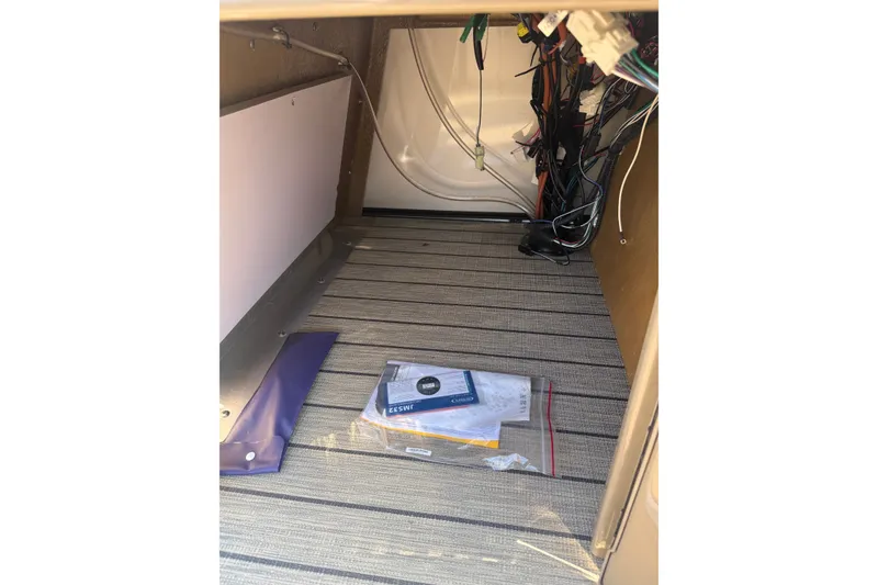 Slide: The Image of Interior view of 2023 Sylvan Mirage X X1 boat wiring and storage area. - 36