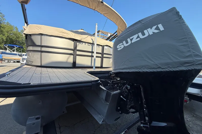 Slide: The Image of 2023 Sylvan Mirage X X1 pontoon boat with Suzuki outboard motor, docked outdoors. - 7