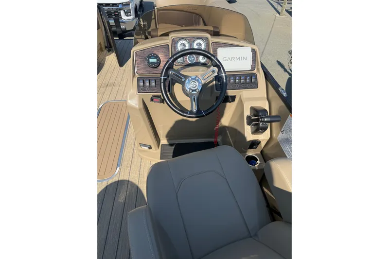Slide: The Image of 2023 Sylvan Mirage X X1 boat dashboard with Garmin navigation system and steering wheel. - 23