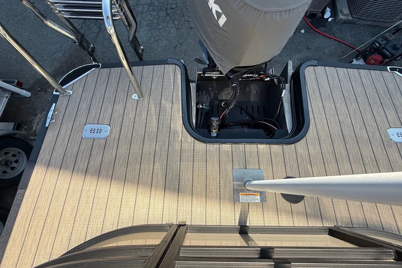 Slide: The Image of 2023 Sylvan Mirage X X1 boat deck with motor and ladder. - 18