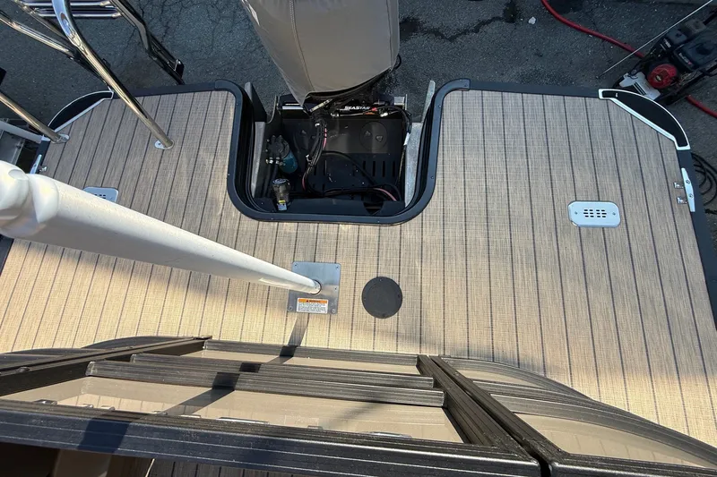 Slide: The Image of 2023 Sylvan Mirage X X1 boat deck with open engine compartment and sleek design. - 19