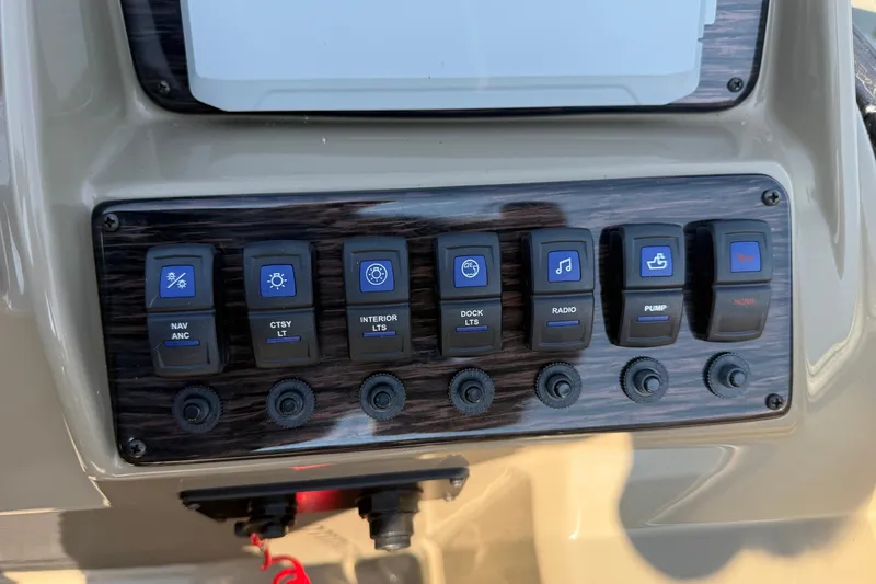 Slide: The Image of Control panel of 2023 Sylvan Mirage X X1 boat with labeled switches and knobs. - 31