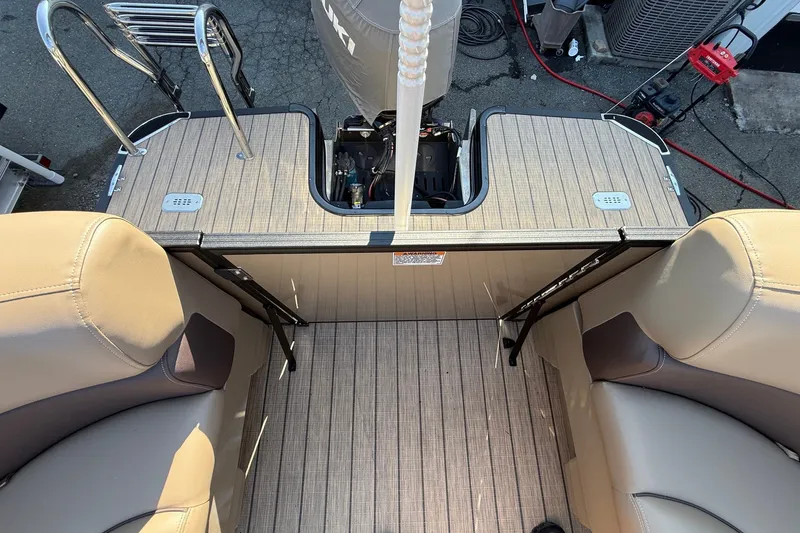 Slide: The Image of 2023 Sylvan Mirage X X1 boat interior with beige seating and wooden flooring. - 16