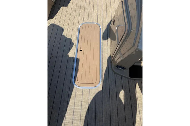 Slide: The Image of 2023 Sylvan Mirage X X1 boat deck with sleek, modern design and wood finish. - 34
