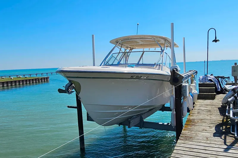 Slide: The Image of 2014 Grady-White Freedom 285 boat docked on a sunny day by the water. - 29
