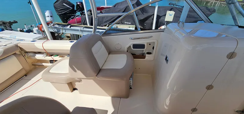 Slide: The Image of 2014 Grady-White Freedom 285 boat interior with seating and control panel. - 19