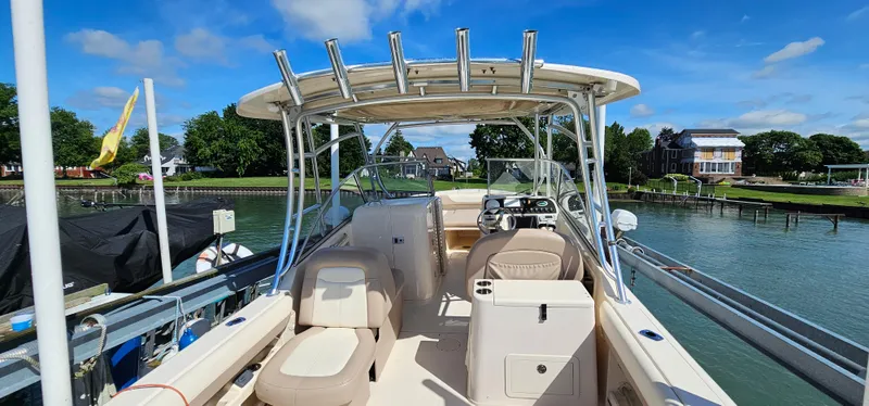 Slide: The Image of 2014 Grady-White Freedom 285 boat docked by a scenic waterfront. - 6