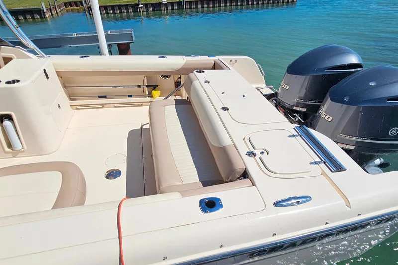 Slide: The Image of 2014 Grady-White Freedom 285 boat interior with twin outboard engines on a sunny day. - 4