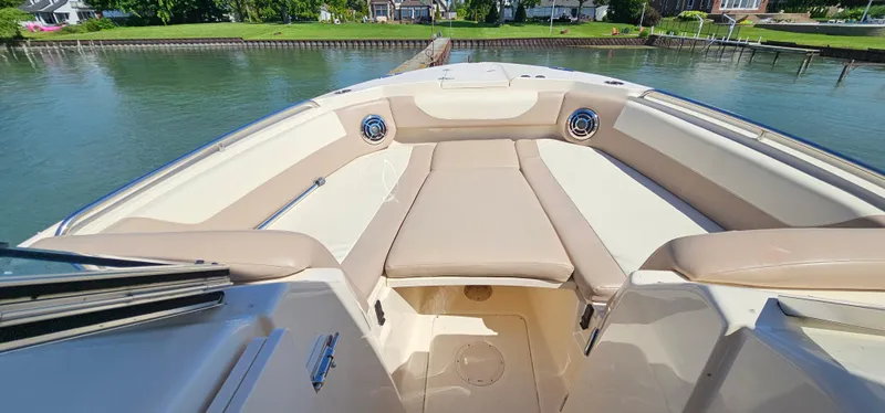 Slide: The Image of 2014 Grady-White Freedom 285 boat interior with beige seating, docked by calm waters. - 24
