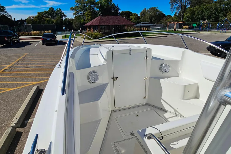 Slide: The Image of 1996 Fountain 31 Tournament Edition boat interior with seating and storage, parked in a lot. - 26