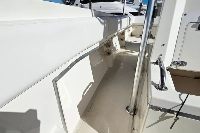 Slide: The Image of 1996 Fountain 31 Tournament Edition boat interior with white seating and stainless steel fixtures. - 24