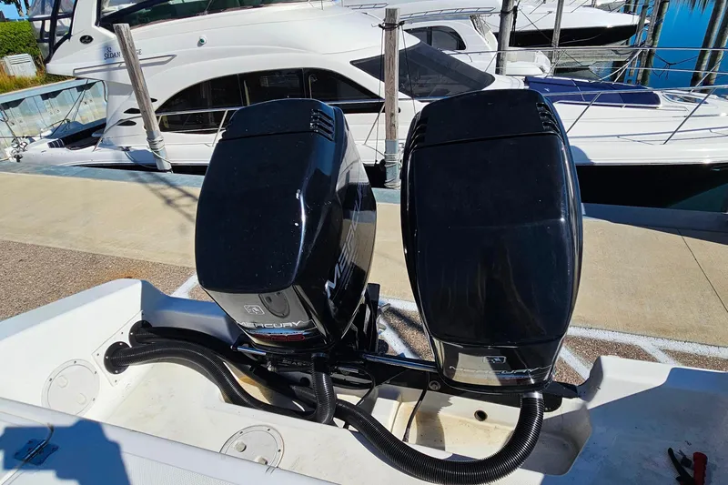 Slide: The Image of Twin Mercury outboard engines on a 1996 Fountain 31 Tournament Edition boat at a marina. - 11