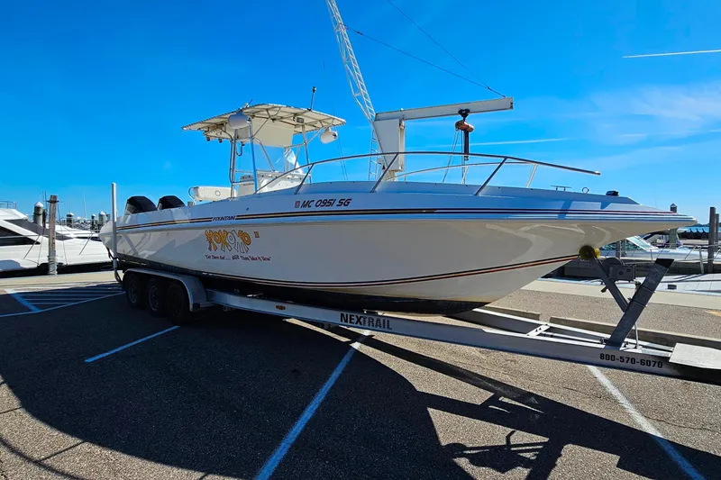 Slide: The Image of 1996 Fountain 31 Tournament Edition boat on trailer in marina parking lot. - 10